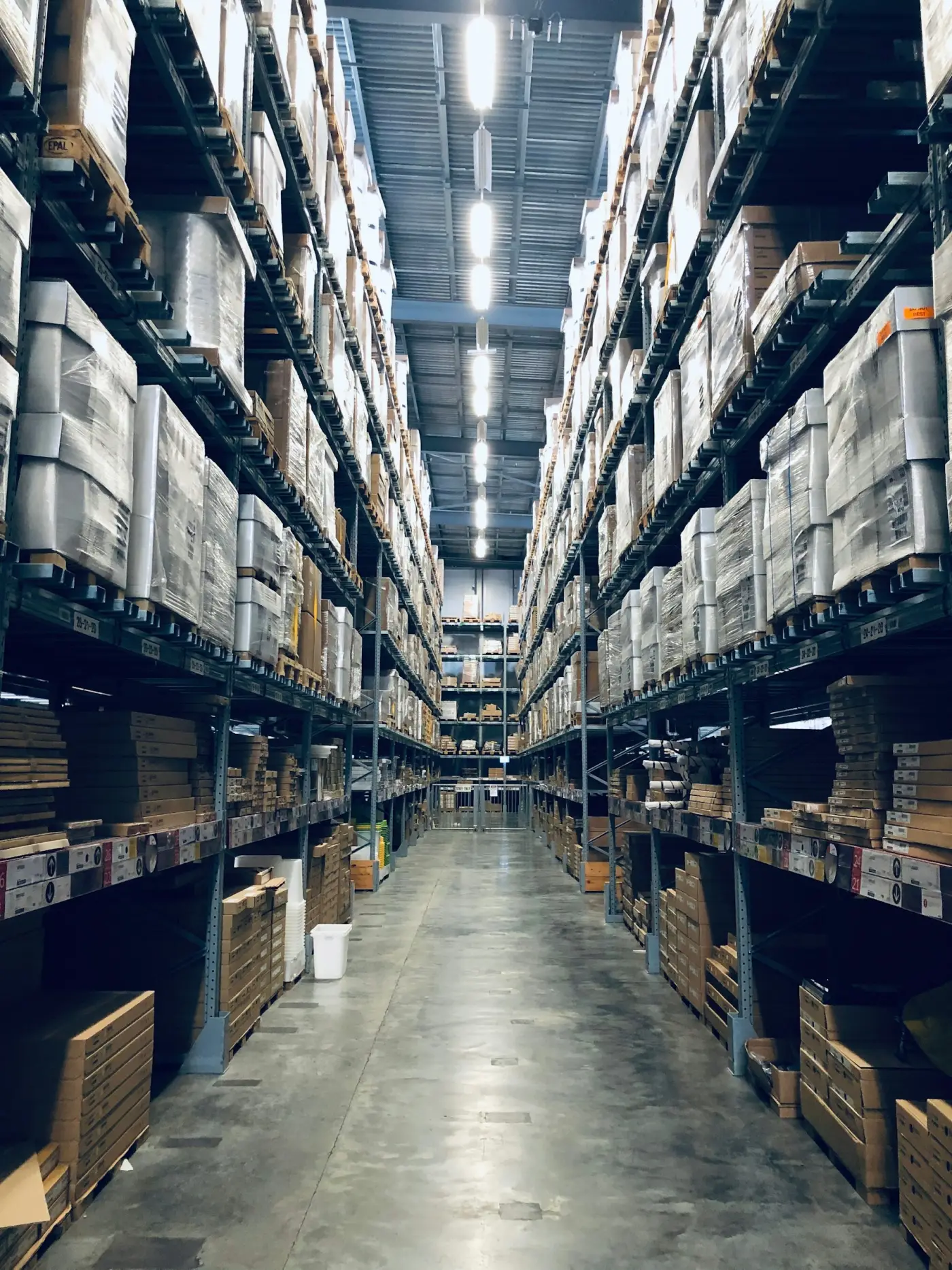 Pallet racking running the length of a warehouse aisle